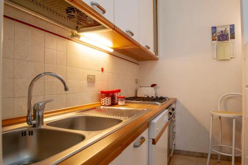 a small kitchen with a sink and a stove at BouganVilla in Polignano a Mare