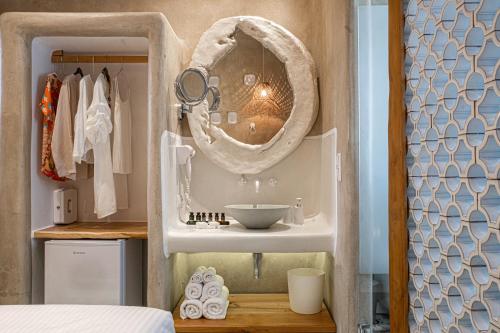 a bathroom with a sink and a mirror at AMMOS at AmazeU Suites Naxos in Naxos Chora