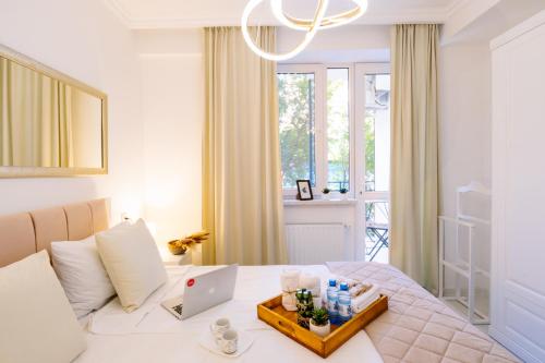 een slaapkamer met een bed en een tafel met een laptop bij hotelise I Mermaid Apartment in Jerevan