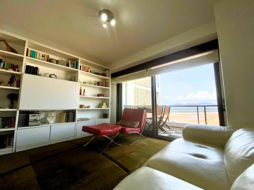a living room with a view of the ocean at Apartamento Playa Calzoa in Vigo