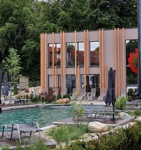 a building with a swimming pool in front of a building at Vitalhotel Bad Birnbach in Bad Birnbach