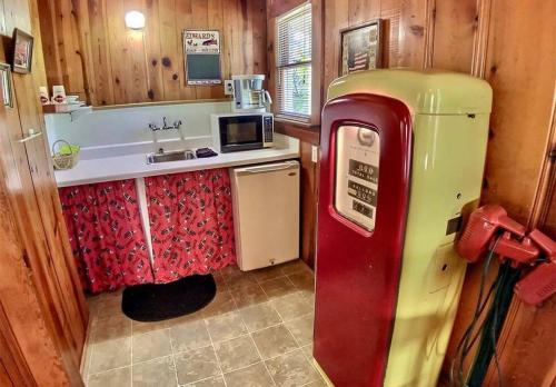 an old fashioned refrigerator in a kitchen with a sink at Suite Memories #5/ Oak Crest in Eureka Springs
