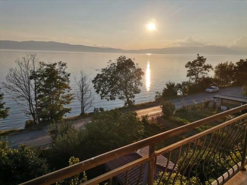 a view of a body of water with the sun setting at Guesthouse Zimovski in Peštani
