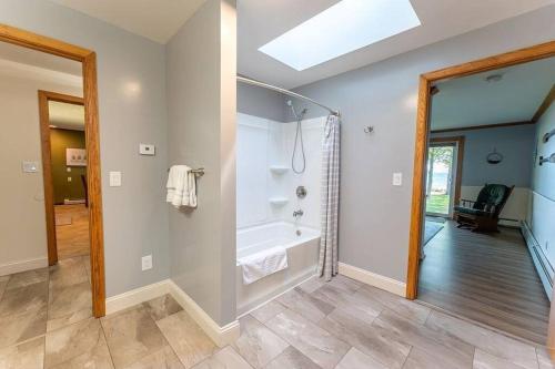 a bathroom with a tub and a walk in shower at Beautiful home on Lake Michigan, near Escanaba 