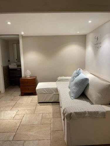 a bedroom with a bed and a bathroom at L'antico Trullo - Masseria Chiancarella in Fasano