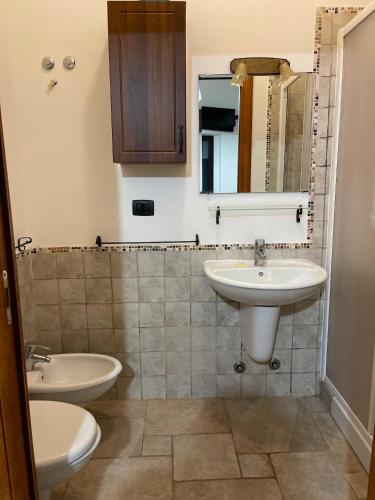 a bathroom with two sinks and a mirror at L'antico Trullo - Masseria Chiancarella in Fasano
