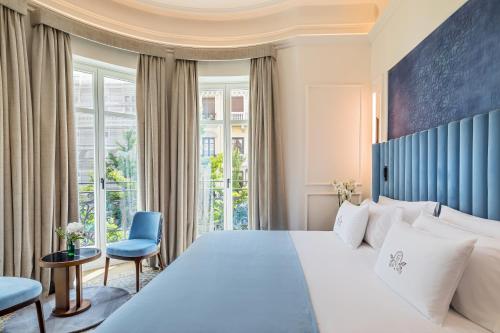 a bedroom with a large bed and a window at Palacio Gran Vía, a Royal Hideaway Hotel in Granada