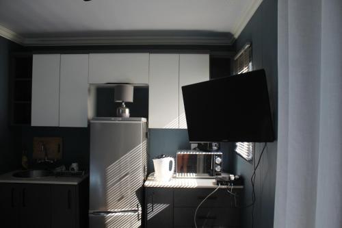 a kitchen with a stainless steel refrigerator and a microwave at Isikhoma-Khoma in Hilton