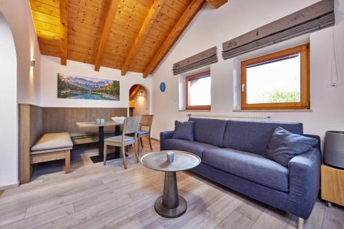 a living room with a couch and a table at Haus Alpklang in Garmisch-Partenkirchen