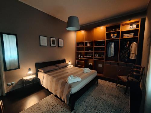 a bedroom with a bed and a chair in it at Casa Vinci in Syracuse
