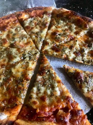 four slices of pizza sitting on top of a table at Sitha's Heaven in Ella