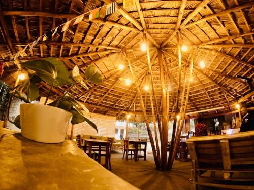 a restaurant with a table with a potted plant on it at Sitha's Heaven in Ella