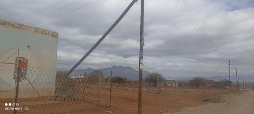 a construction crane standing next to a dirt road at Nakedi Accommodation Services in Burgersfort