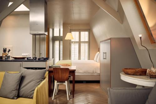 a kitchen and a living room with a table at Hotel Miss Blanche in Groningen