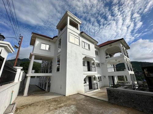 a large white building with a sky at After 5 Apartment 1- 3 spacious en-suite bedrooms in Freetown