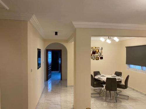 a dining room with a table and chairs at After 5 Apartment 1- 3 spacious en-suite bedrooms in Freetown