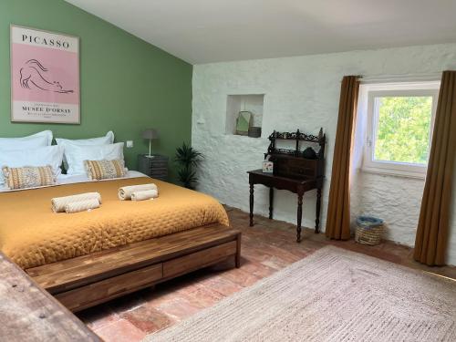 a bedroom with a bed with two pillows on it at Le Domaine de Villespy in Villespy