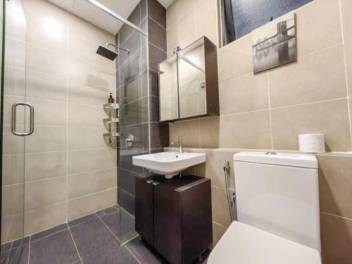 a bathroom with a white toilet and a sink at D'Pristine Theme Suite by Nest Home at LEGOLAND in Nusajaya