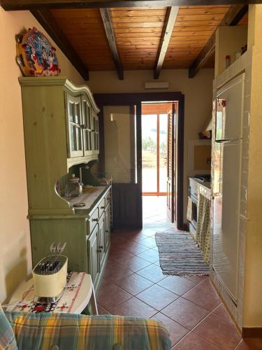 a kitchen with a green stove top oven next to a door at Casa a San Vito Lo Capo con giardino in San Vito lo Capo