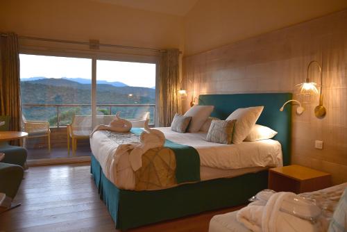 a bedroom with a bed with two teddy bears on it at Hôtel Alivi Di Santa Giulia in Porto-Vecchio