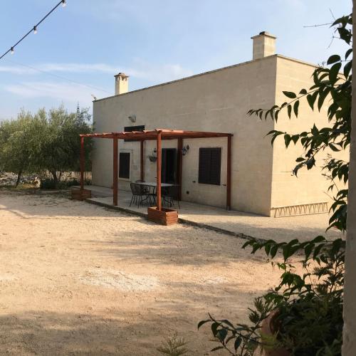 a building with a picnic table in front of it at L'antico Trullo - Masseria Chiancarella in Fasano