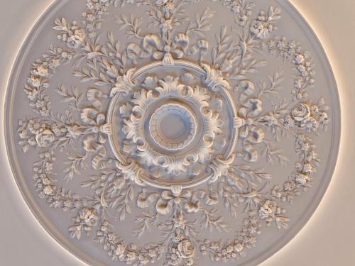 an ornate ceiling with a mirror in the middle at Palacio Gran Vía, a Royal Hideaway Hotel in Granada