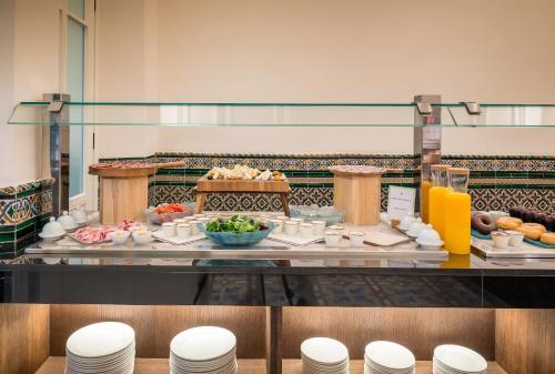 a buffet with food and drinks on a table at Palacio Gran Vía, a Royal Hideaway Hotel in Granada