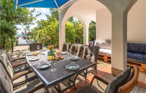 a table and chairs on the patio of a house at 3 Bedroom Amazing Home In Kraljevica in Kraljevica