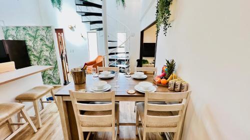 - une salle à manger avec une table et des chaises en bois dans l'établissement Miyako Blue Villa Kugai, à Île Miyako