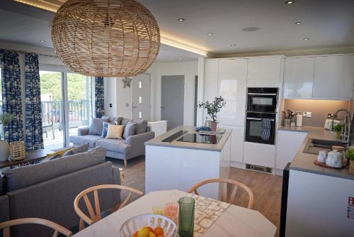 a kitchen and living room with a table and chairs at Gwel an Mor in Portreath