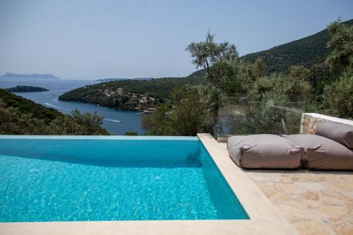 a swimming pool with a view of the water at Villa Dara and Todd in Sivota