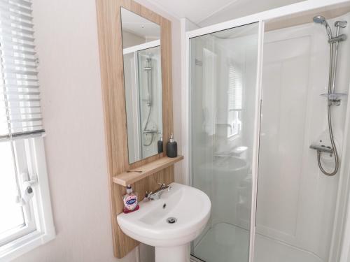 a bathroom with a toilet and a sink and a shower at Moon Stone in Morpeth