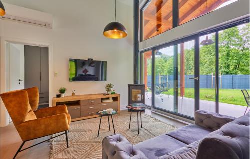 a living room with a couch and a table and a tv at Cozy Home & Spa In Nature in Trakoščansko Jezero