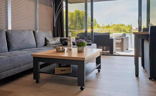 a living room with a couch and a coffee table at Hausboot La Mare Seeblick in Weyhe