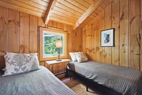 a bedroom with two beds in a wooden cabin at Wilmington Vacation Rental Near Hiking and Skiing! in Wilmington