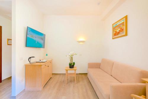 a living room with a couch and a table at Hotel Dei Pini in Alghero