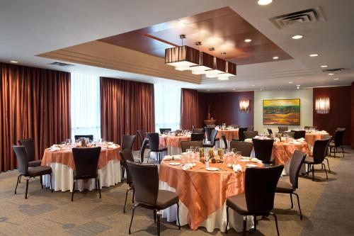 a banquet room with tables and chairs and tablesearcher at The Listel Hotel Vancouver in Vancouver
