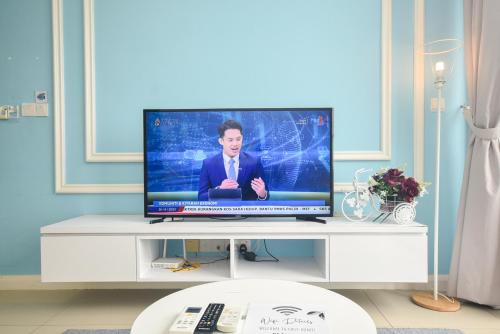 a flat screen tv sitting on a white entertainment center at D'Pristine Theme Suite by Nest Home at LEGOLAND in Nusajaya