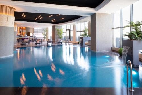 a large swimming pool in a hotel lobby at Kuwait Grand Hotel in Kuwait
