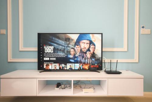 a flat screen tv sitting on top of a white entertainment center at D'Pristine Theme Suite by Nest Home at LEGOLAND in Nusajaya