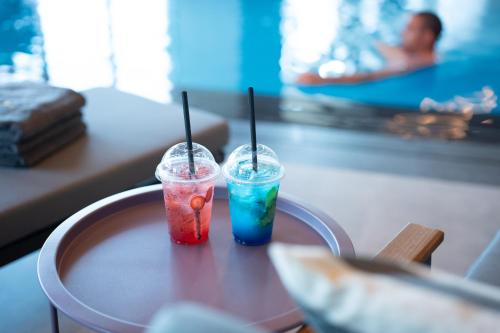 two drinks are sitting on a table at Kuwait Grand Hotel in Kuwait