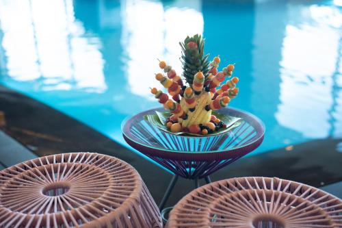 a small plant in a bowl on a glass table at Kuwait Grand Hotel in Kuwait