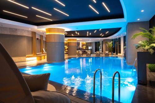 a large swimming pool in a hotel lobby at Kuwait Grand Hotel in Kuwait