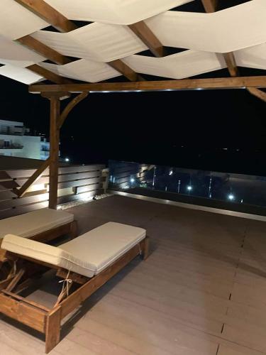 a room with a bed and a wooden ceiling at Vento di Mare in Perea