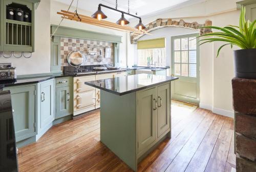 a large kitchen with a large island in the middle at Host & Stay - Beckside in Pickering