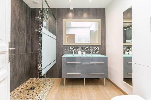 a bathroom with a blue sink and a shower at Le Chateaubriand in Dijon