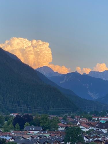 a town in a valley with mountains in the background at Alpenappartements Schwalbennestl in Mittenwald