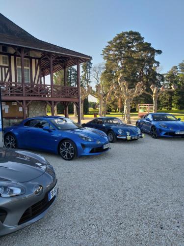 a row of blue cars parked in front of a building at Demeures & Châteaux Le Pavillon d'Enghien, Vichy Centre in Vichy