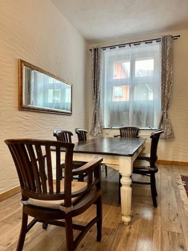 a dining room with a table and chairs and a window at Domizil in Schleiden