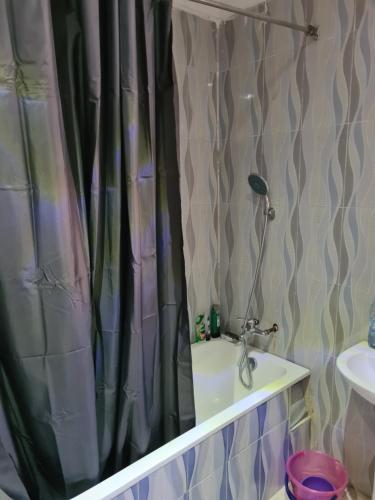 a shower curtain in a bathroom with a sink at koka in Ibadan